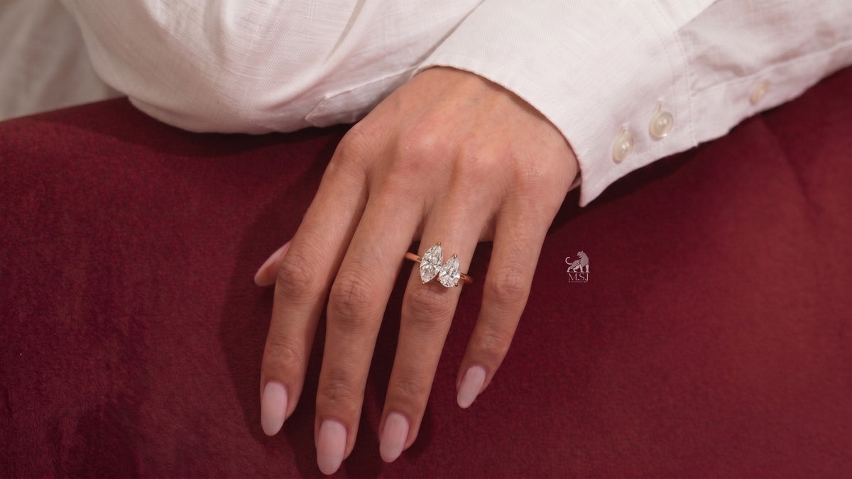 Marquise and Pear Diamond Toi et Moi Ring worn on a hand