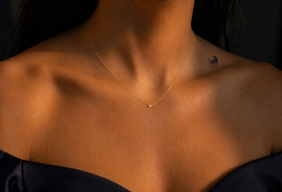 The Solenne Diamond Solitaire Necklace worn around the neck