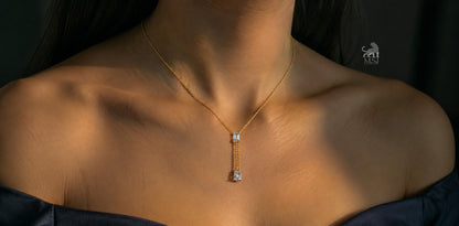 The Elara Emerald & Pear Drop Necklace worn around the neck