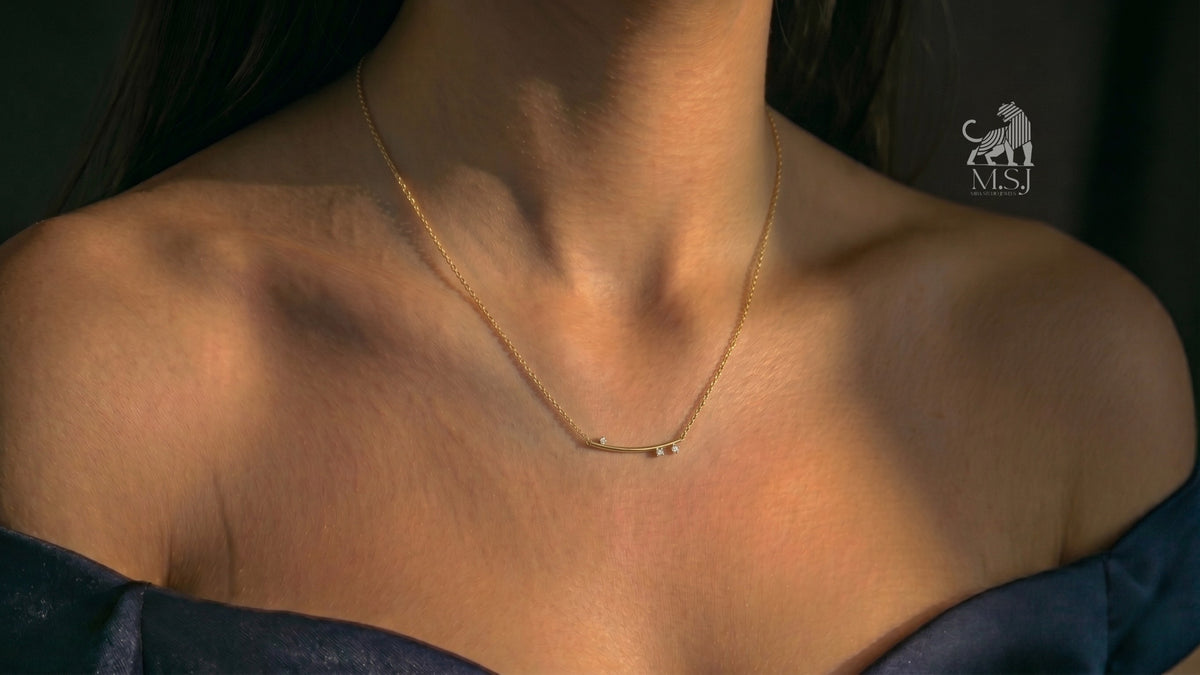 The Celeste Arc Diamond Bar Necklace worn around the neck