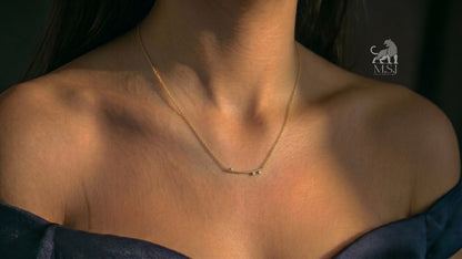 The Celeste Arc Diamond Bar Necklace worn around the neck