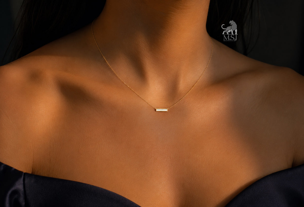 The Élan Baguette Bar Diamond Necklace worn around the neck