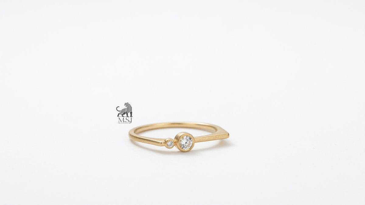 The Solenne Twin Diamond Bezel Ring in yellow gold